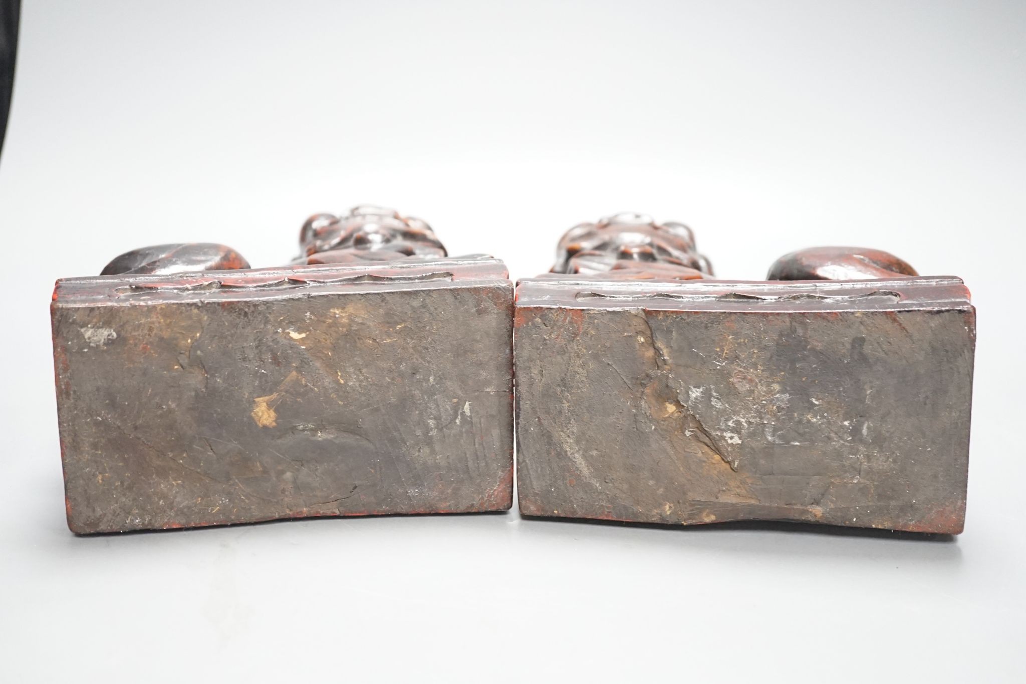 A pair of Japanese carved and red lacquered wood models of temple dogs, Edo period, 21.5 cms high.